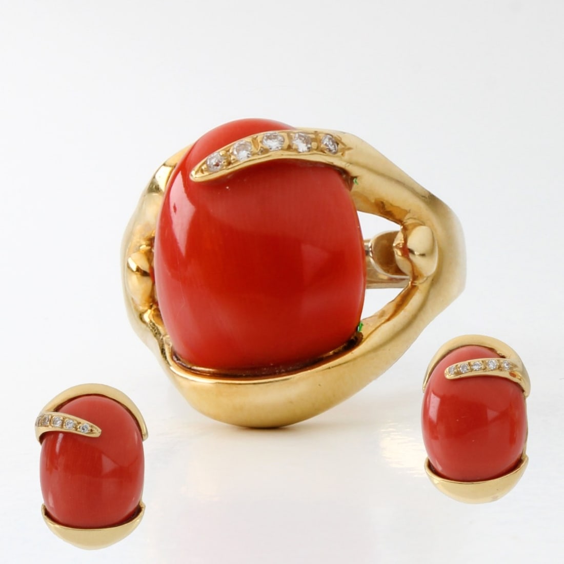 Coral Diamond and 18K Jewelry: Vintage Red Coral, Approx. .45 Carat TW Round Brilliant Cut Diamond and 18 Karat Yellow Gold Ring and Earrings. Ring size 7. Approx. total weight: 24.74 grams.Kodner Galleries offers phone and