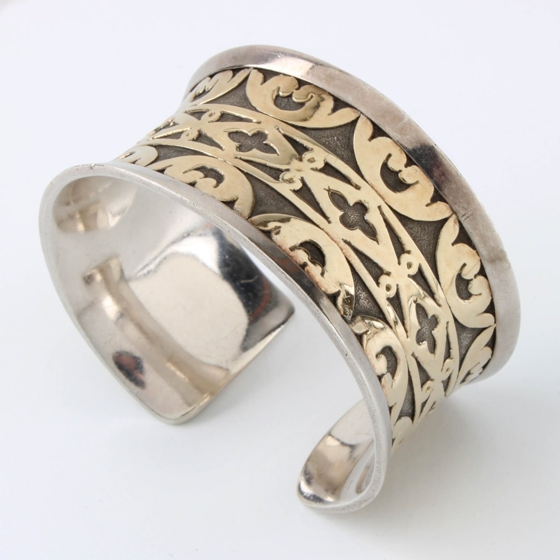 John Hardy Sterling and 18K Cuff Bangle: John Hardy Sterling Silver and 18 Karat Yellow Gold Wide Cuff Bangle. Signed (logo), 925 18K. Measures 5-1/2" interior circumference plus 1/2" opening. Approx. weight: 57.32 grams. Kodner Galleries of