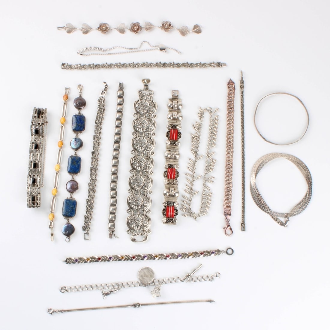 Sterling Bracelets: Collection of Eighteen (18) Sterling Silver Link and Bangle Bracelets. Variously accented with color stones, hardstones, faux diamonds and pearls. Wide bracelet measures 7" L, 1" W. Approx. total