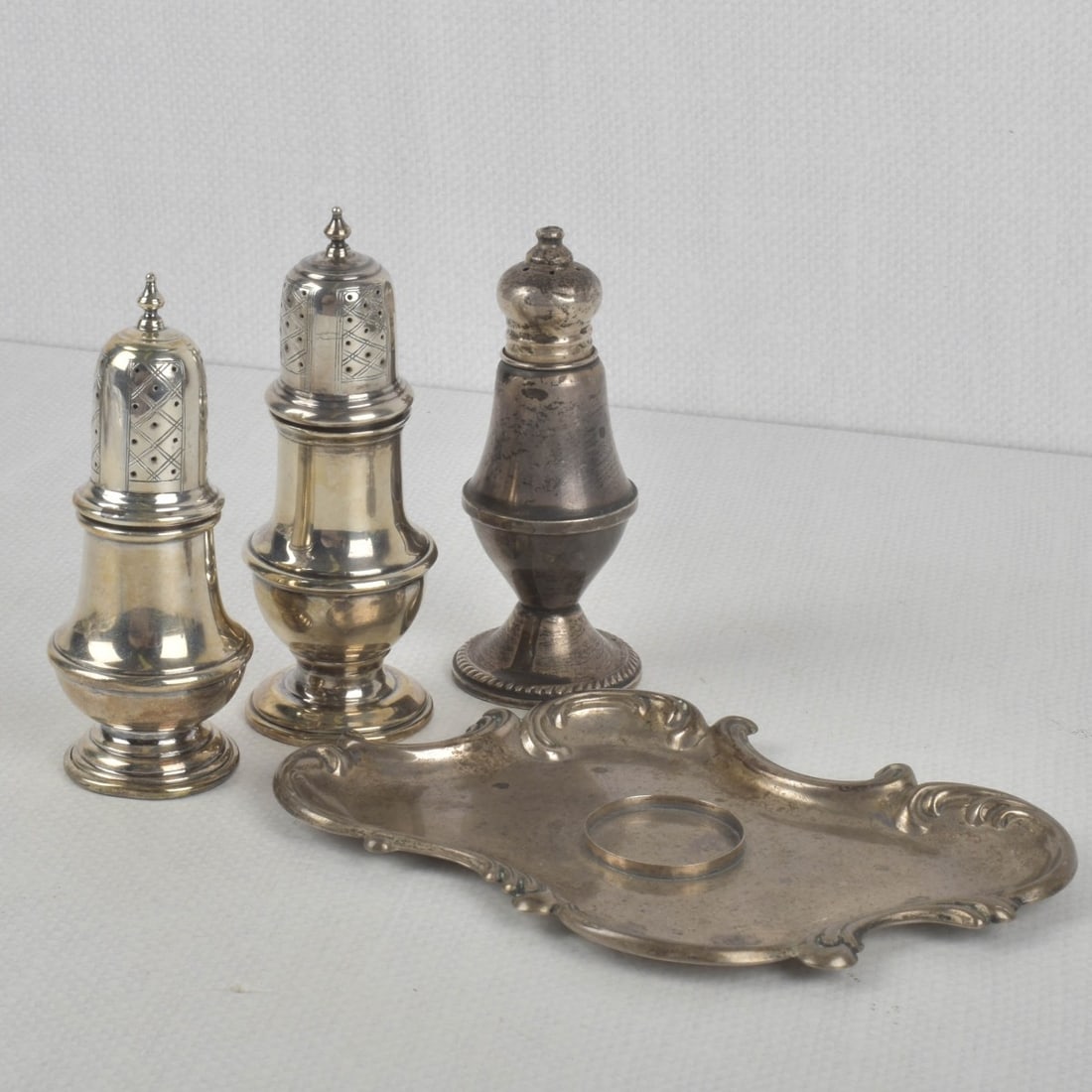 Sterling Silver Pieces: Four (4) Sterling Silver Pieces. All properly marked to the bottoms. Consisting of one (1) tray, measures: 6-1/2" long, 4-1/2" wide, two (2) shakers, tallest measures: 4-3/4" high, one (1) shaker