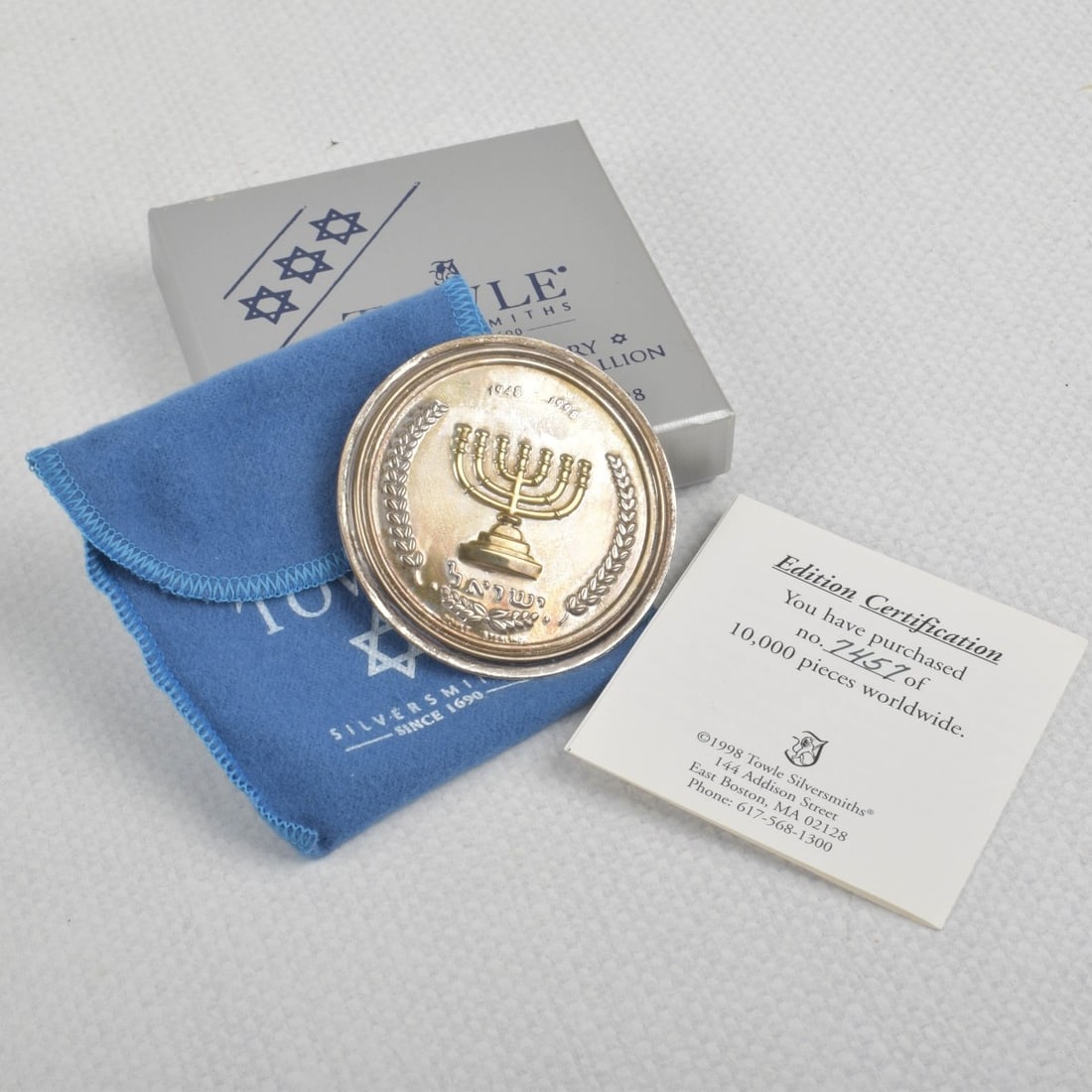 Towle Sterling Silver Medallion: Sterling Silver 1948-1998 Towle Isreal 50th Year Commemorative Medallion with Original box and Certification. Number 7457 of 10,000. Total weight: 13.70 grams. Kodner Galleries offers phone and