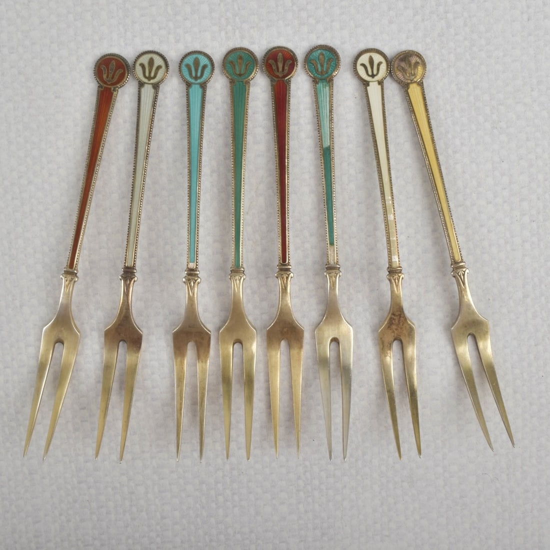David Anderson Sterling SIlver Forks: Eight (8) David Anderson Norway Sterling Silver and Enamel Cocktail Forks. Each properly stamp to the back of handle. Measures: 4-1/8" long. Weight: 69.40 grams. Kodner Galleries offers phone and