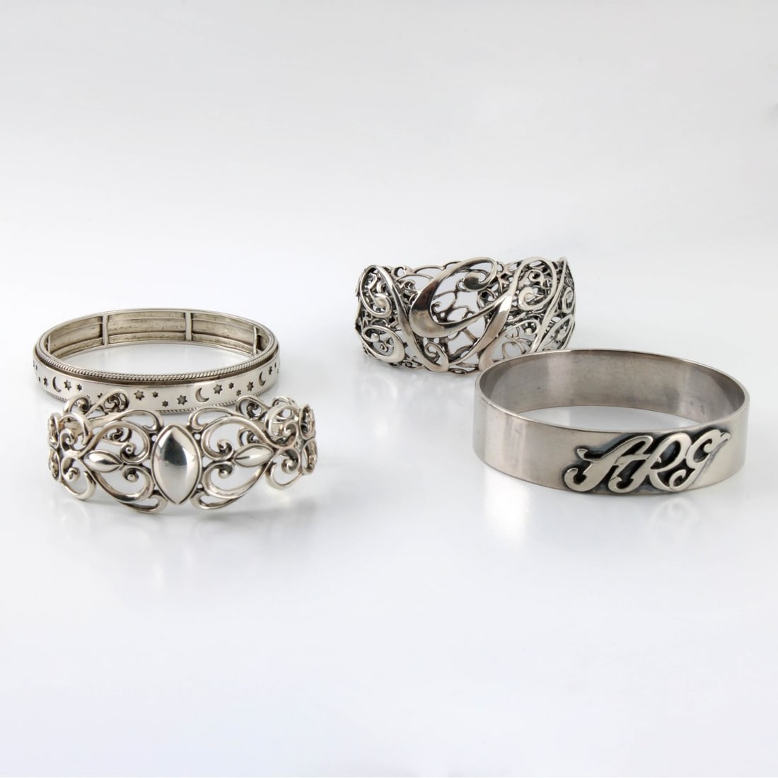 Sterling Bangle Bracelets: Four (4) Heavy Sterling Silver Cuff Bangle Bracelets. One with 'ARG" monogram. ARG monogram bracelet measures 7-1/2" interior circumference. Approx. total weight: 144.37 grams. Kodner Galleries