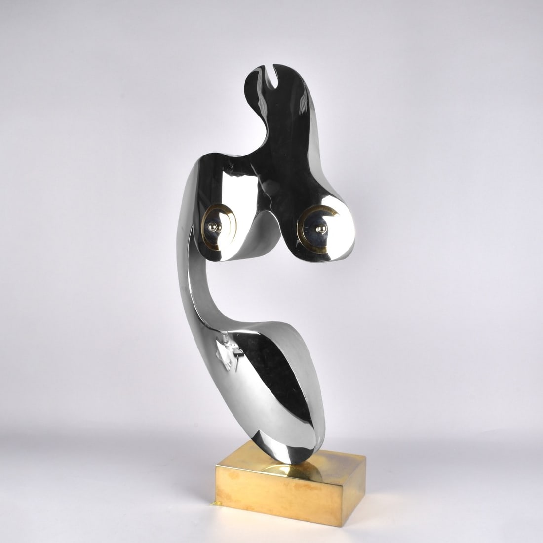 Abstract Sculpture of Woman's Torso: Modern Abstract Sculpture of Woman's Torso in Chrome with Brass Accents and Plinth. Unsigned. Measures 26" H,14" W, 5-1/2" D. Kodner Galleries offers phone and absentee bidding at a low, flat 21%