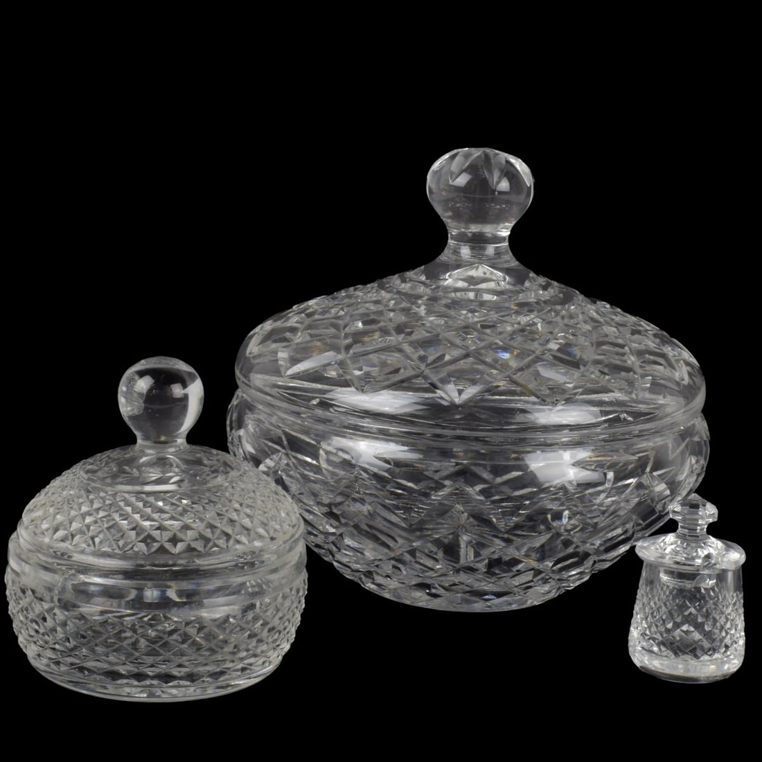 Waterford Cut Crystal: Three (3) Waterford Cut Crystal Pieces with Corresponding Lids. Consisting of one (1) large Lismore candy bowl, measures: 8" high, 7-1/4" diameter, one (1) small Glandore candy dish, measures: 4-1/2"