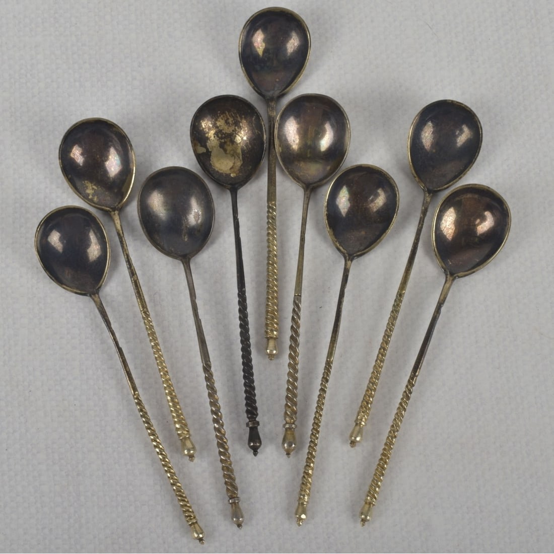 Antique Gold-wash Russian 84 Silver Spoons: Nine (9) Antique Gold-wash Russian 84 Engraved Silver Spoons with Twisted Handles. Each marked to the side handle (some are monogrammed). Measures: 5" long. Circa 1880. Total weight: 119.50 grams.