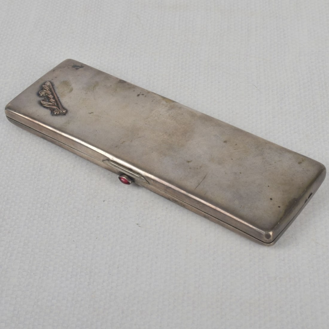 Russian 84 Silver Locking Clutch: Russian 84 Silver Locking Clutch Moire Fabric Interior. Properly stamped to the side. Measures: 6-3/4" long, 2-1/4" deep, 1/2" high. Total gross weight: 6.25 troy ounces. Kodner Galleries offers