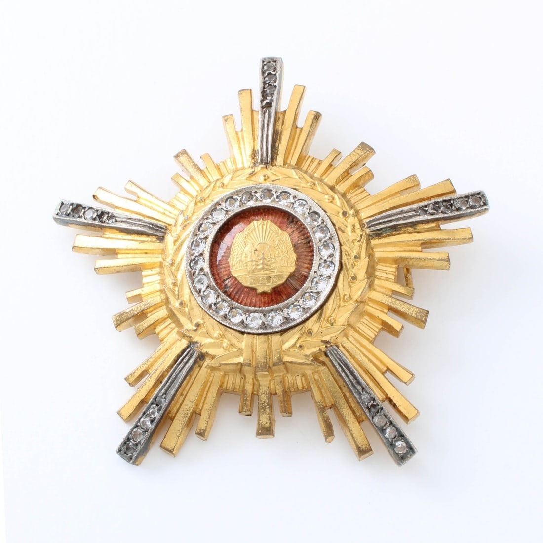 Romanian Order of the Star: Romanian Order of the Star Breast Star. Gilt Tombac with a central enamel, and adorned with pastes with a thin pin back. Kodner Galleries offers phone and absentee bidding at a low, flat 21% buyer?s p