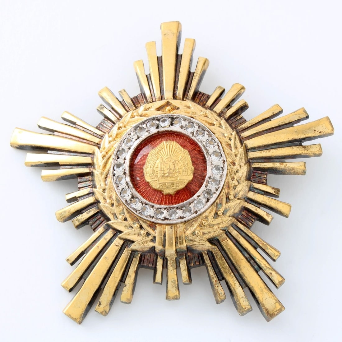 Romanian Order of the Star: Romanian Order of the Star Breast Star. Gilt Tombac with a central enamel, and adorned with pastes with a Thin Pin Back. Measures: 2-1/2" wide, 2-1/2" high, total gross weight: 44.80 grams. Kodner Gal