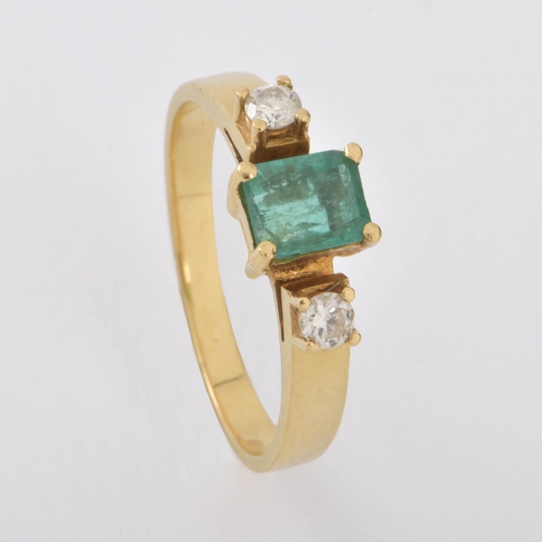 Emerald, Diamond and 18K Ring: Vintage Approx. .75 Carat Colombian Emerald, Round Brilliant Cut Diamond and 18 Karat Yellow Gold Ring. Emerald with good color. Diamonds G-H color, SI clarity. Stamped 18K. Ring size 7. Approx.