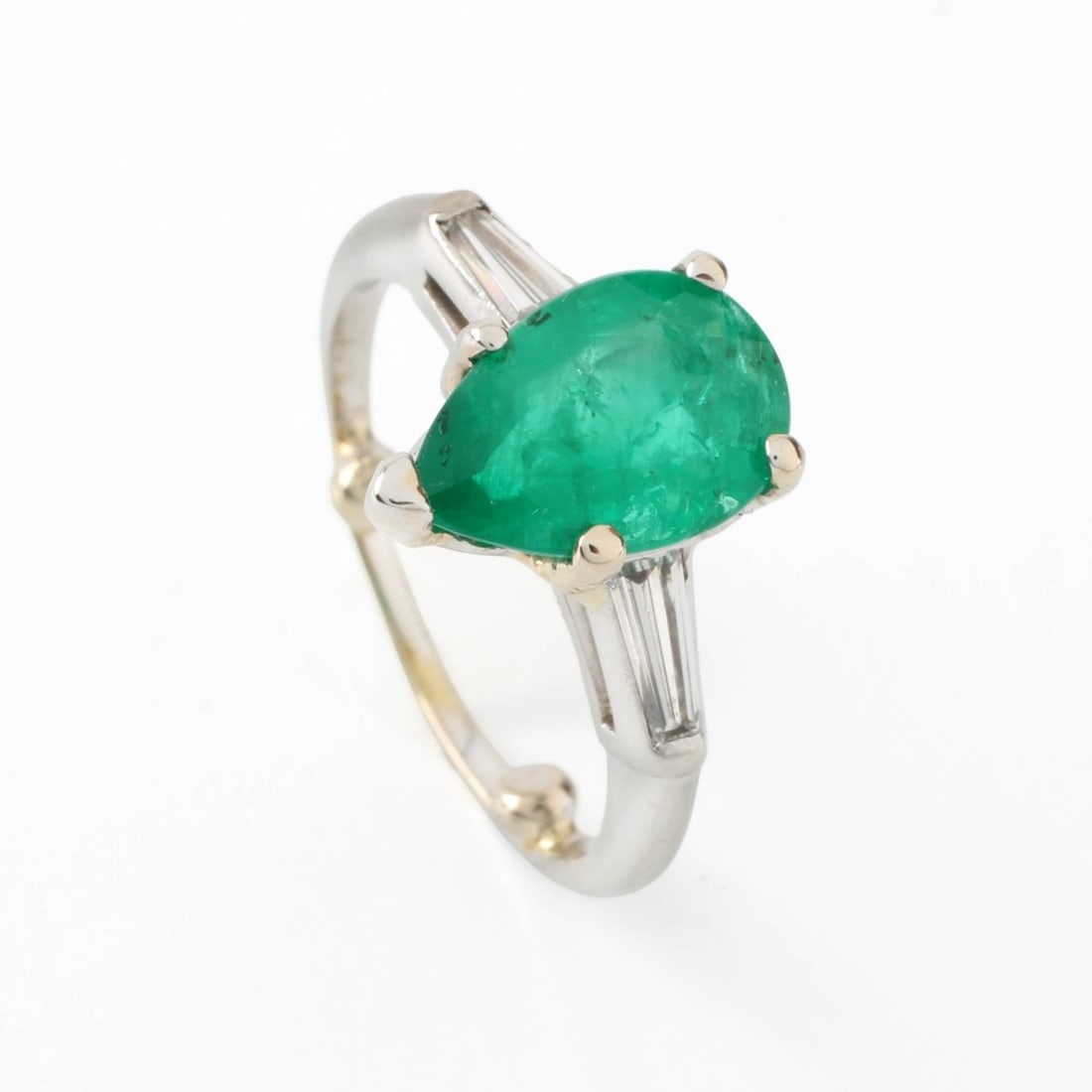 Emerald, Diamond and Plat Ring: Vintage Approx. 2.40 Carat Pear Shape Colombian Emerald and Platinum Ring Accented with Two Small Tapered Baguette Cut Diamonds. Emerald with vivid color. Diamonds E-F color, VS clarity. Stamped 10%.