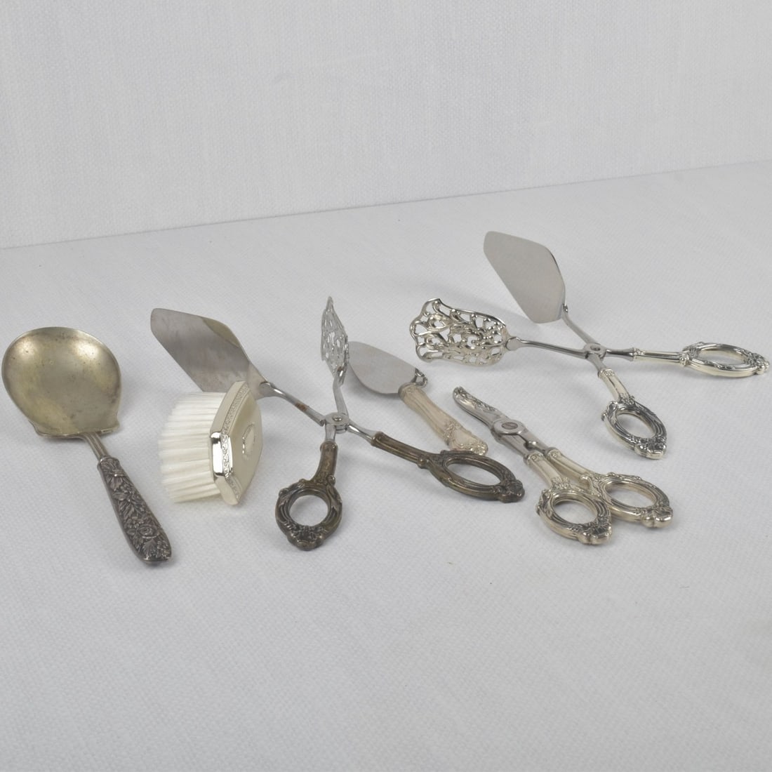 Sterling Silver Pieces: Six (6) Sterling Silver Pieces. All properly stamped. Consisting of one (1) small hair brush, measures: 3" long, one (1) large serving spoon, measures: 8-1/4" long, two (2) pastry tongs, measures: 9-3