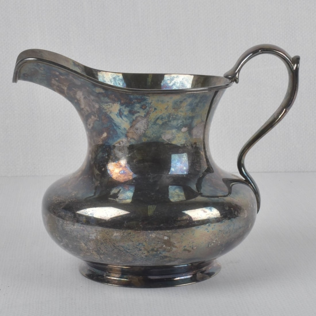 800 Silver Water Pitcher: 800 Silver Water Pitcher. Stamped "800" to the bottom. Measures: 6-1/2" high, widest point measures: 8" wide, Total weight: 21.42 troy ounces. Kodner Galleries offers phone and absentee bidding at a