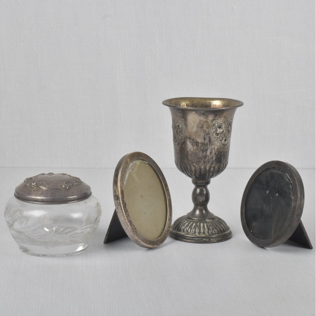 Tiffany & Co Sterling Silver: Tiffany & Co Sterling Silver Photo Frames Along with a Goblet and Dresser Box. All properly stamped. Consisting of two (2) Tiffany & Co photo frames, one (1) oval frame measures: 3-3/4" high, one (1)