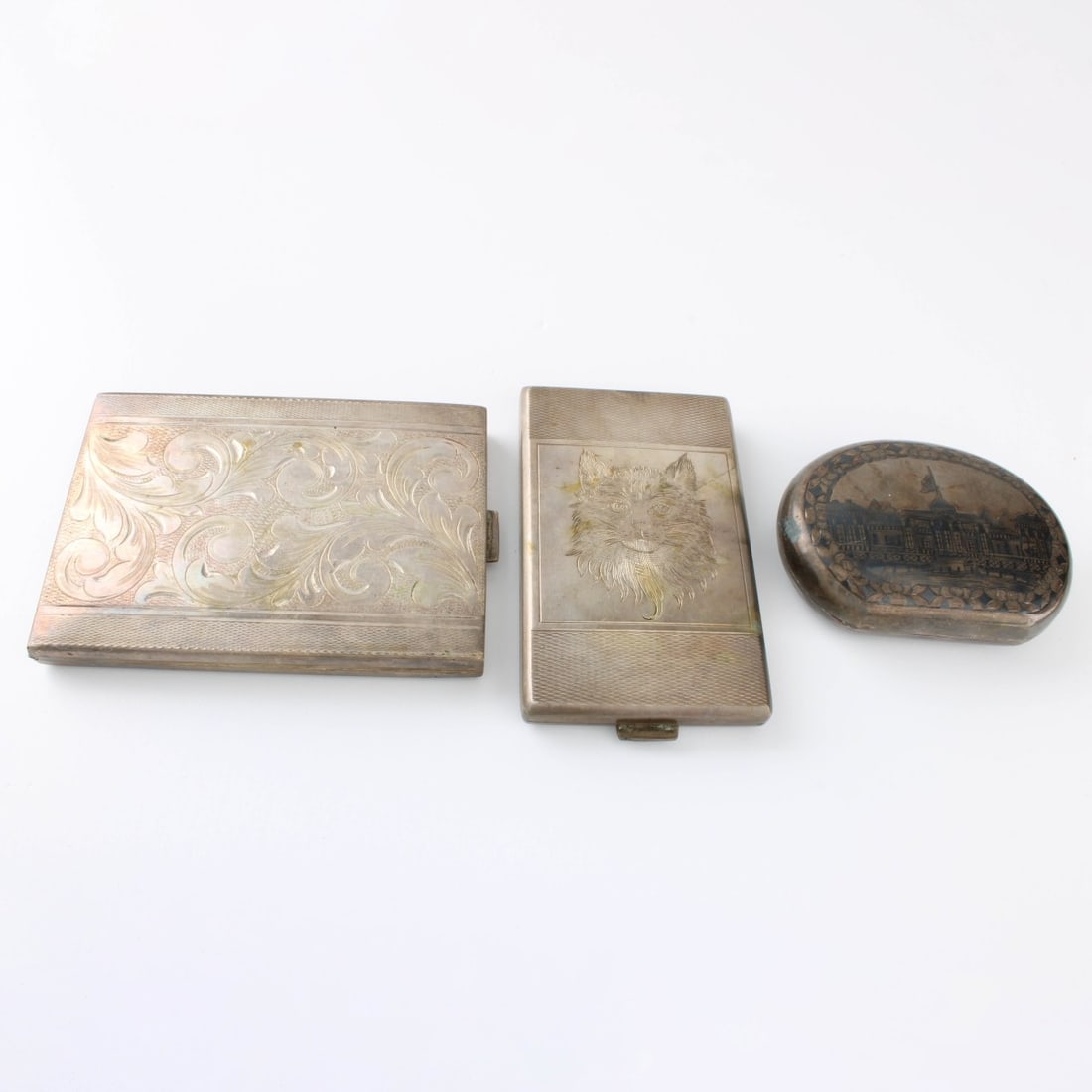 800 Silver Cigarette Cases: Three (3) Vintage 800 Silver Cigarette Cases. Each with overall etched design tops. Each stamped 800. Largest measures 3-1/2". Approx. total weight: 6.87 troy ounces. Kodner Galleries offers phone