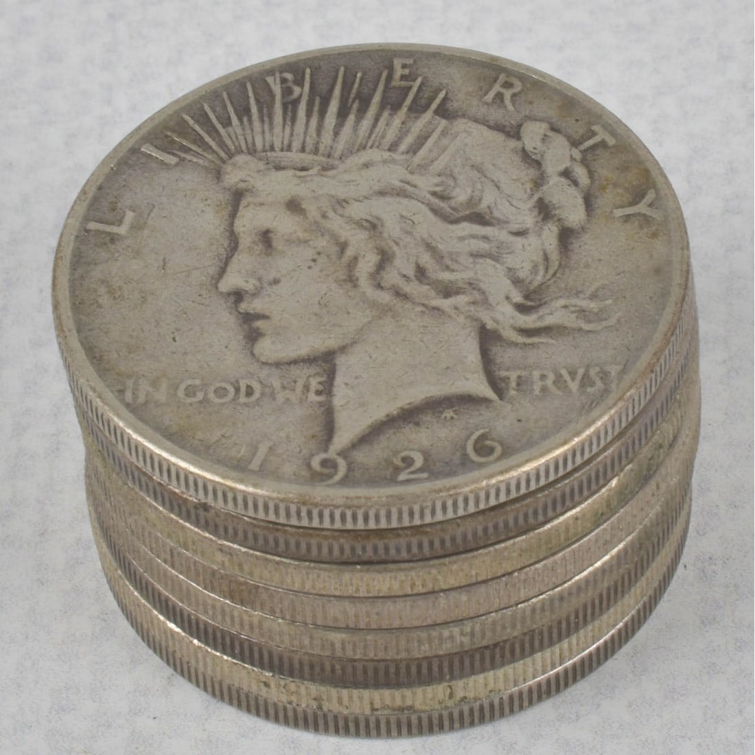 US Silver Dollar Coins: Eight (8) US Liberty Peace Silver Dollars. Consisting of four (4) 1922, two (2) 1923, one (1) 1926. Total weight: 213.50 grams. Kodner Galleries offers phone and absentee bidding at a low, flat 21% bu