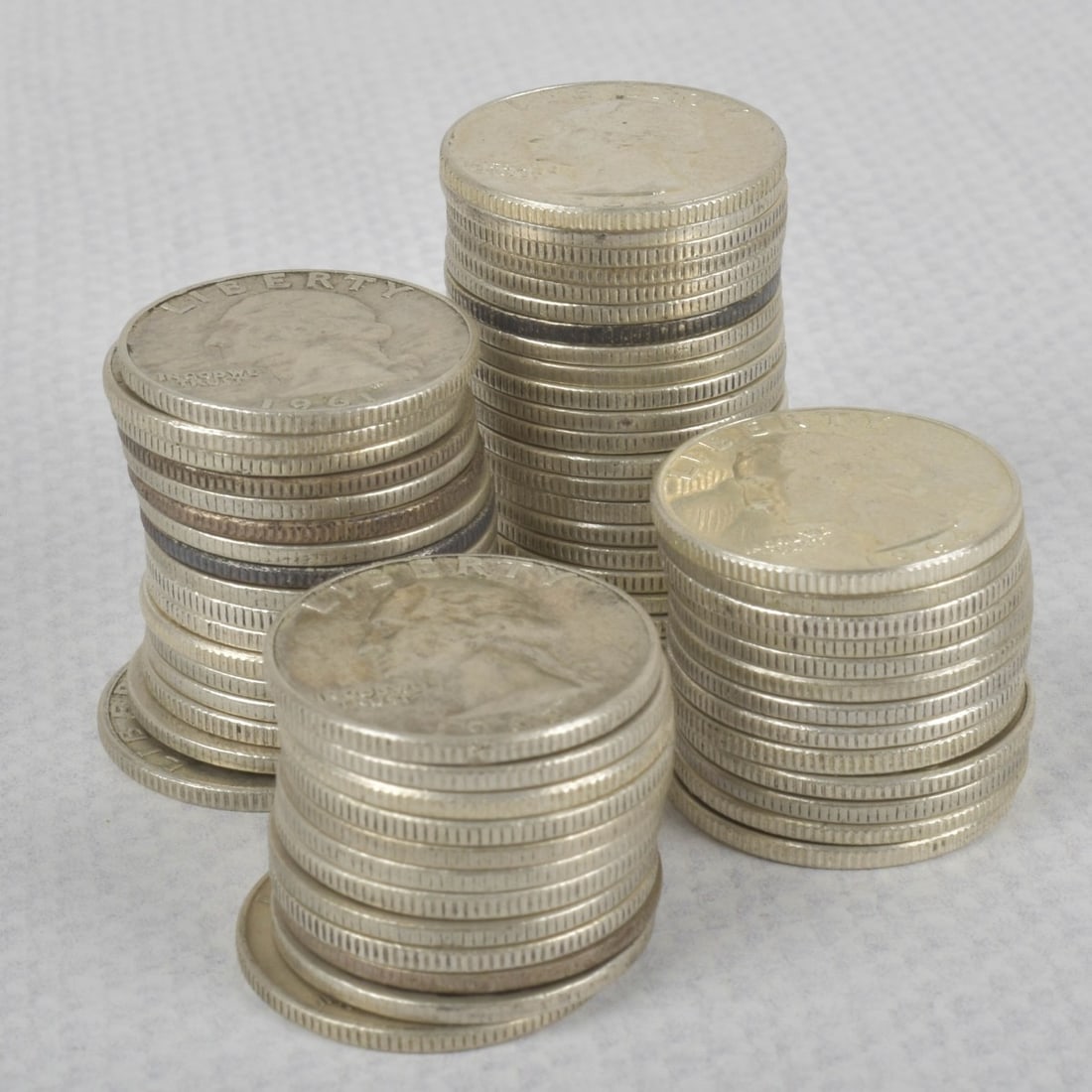 Washington Liberty Silver Quarters: Lot of Sixty-four (64) 90% Washington Liberty Silver Quarters. Circulated random dates. Total weight: 393.50 grams. Kodner Galleries offers phone and absentee bidding at a low, flat 21% buyer?s