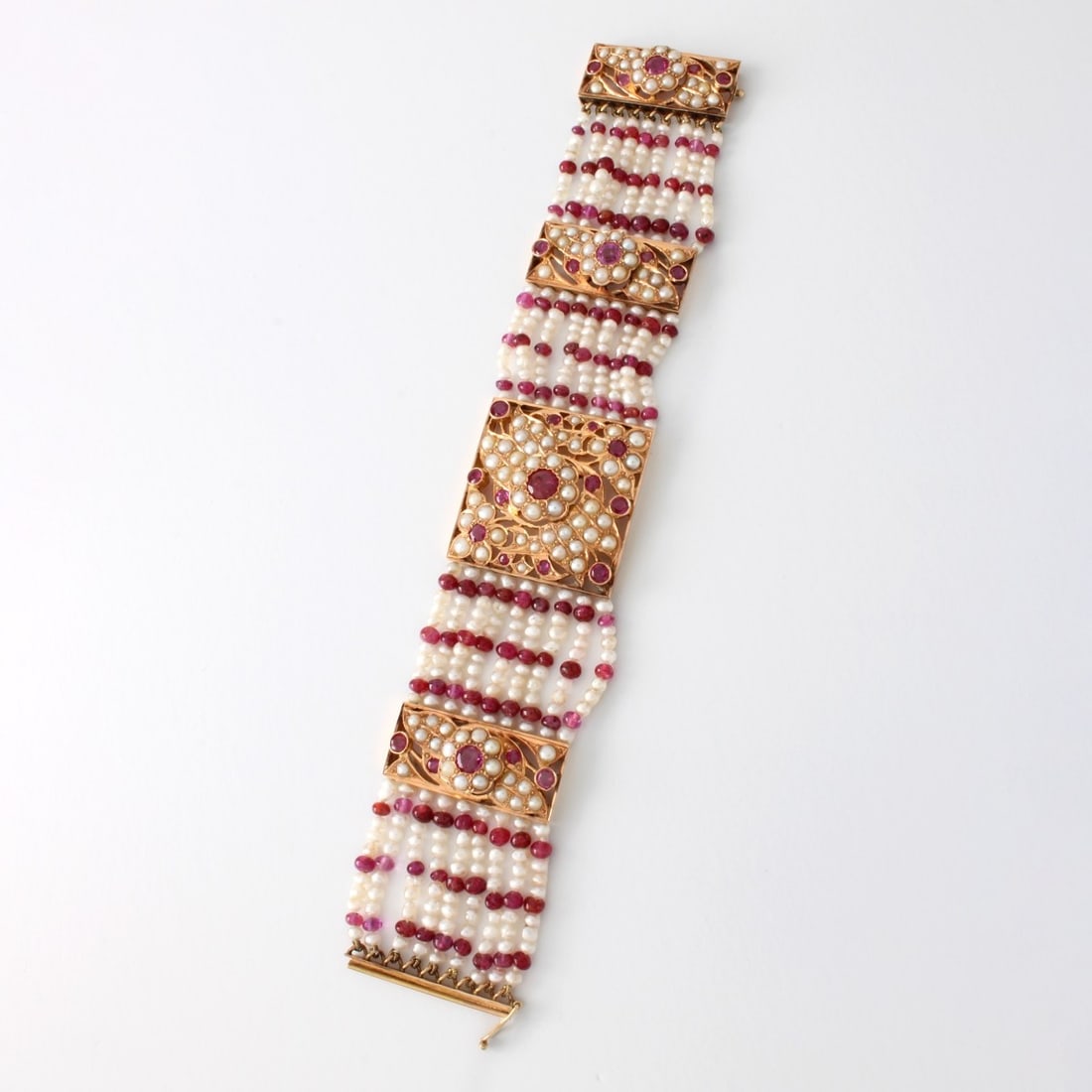 Pearl, Ruby and 14K Bracelet: Antique Indian Natural Seed Pearl, Round Cut Ruby and Ruby Bead and 14 Karat Yellow Gold Multi-strand Wide Bracelet. Rubies with vivid color, largest ruby approx. .85 carat. Measures 6-1/2" L, 1" W. A