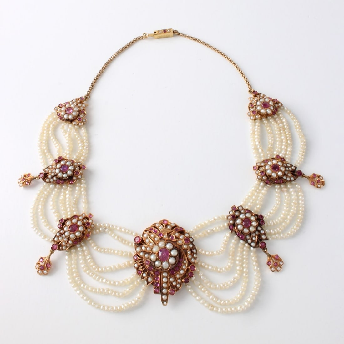 Pearl, Ruby and 14K Necklace: Antique 19th Century Indian Natural Pearl, Round Cut Ruby and 14 Karat Yellow Gold Necklace. Center ruby weighs approx. 1.0 carat. Rubies with vivid color. Measures 16" L. Approx. weight: 69.28 grams.