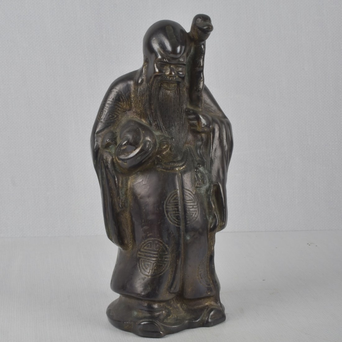 Antique Chinese Bronze Figure: Antique Chinese Bronze Figure with Gold Highlights Depicting Shou-God of Longevity. Measures: 12-1/2" high.5-1/4" wide, 3-3/4" deep. Kodner Galleries offers phone and absentee bidding at a low, flat