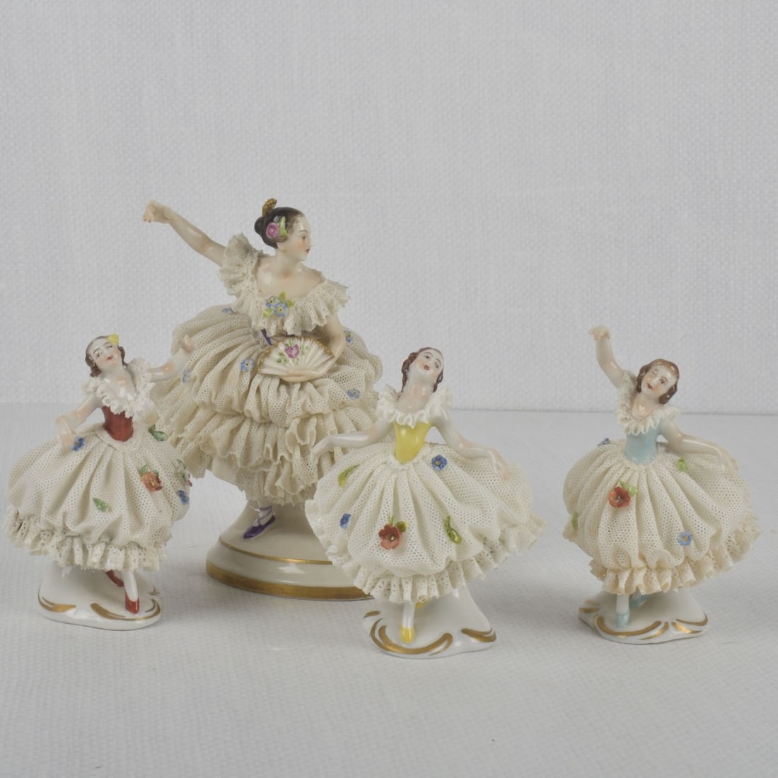 German Rudolstadt Volkstedt Figures: Four (4) German Rudolstadt Volkstedt Lace Porcelain Ballerina Figures. Properly marked to the undersides. Tallest measures: 6" high, 4-1/2" wide, 3-1/4" deep. Kodner Galleries offers phone and