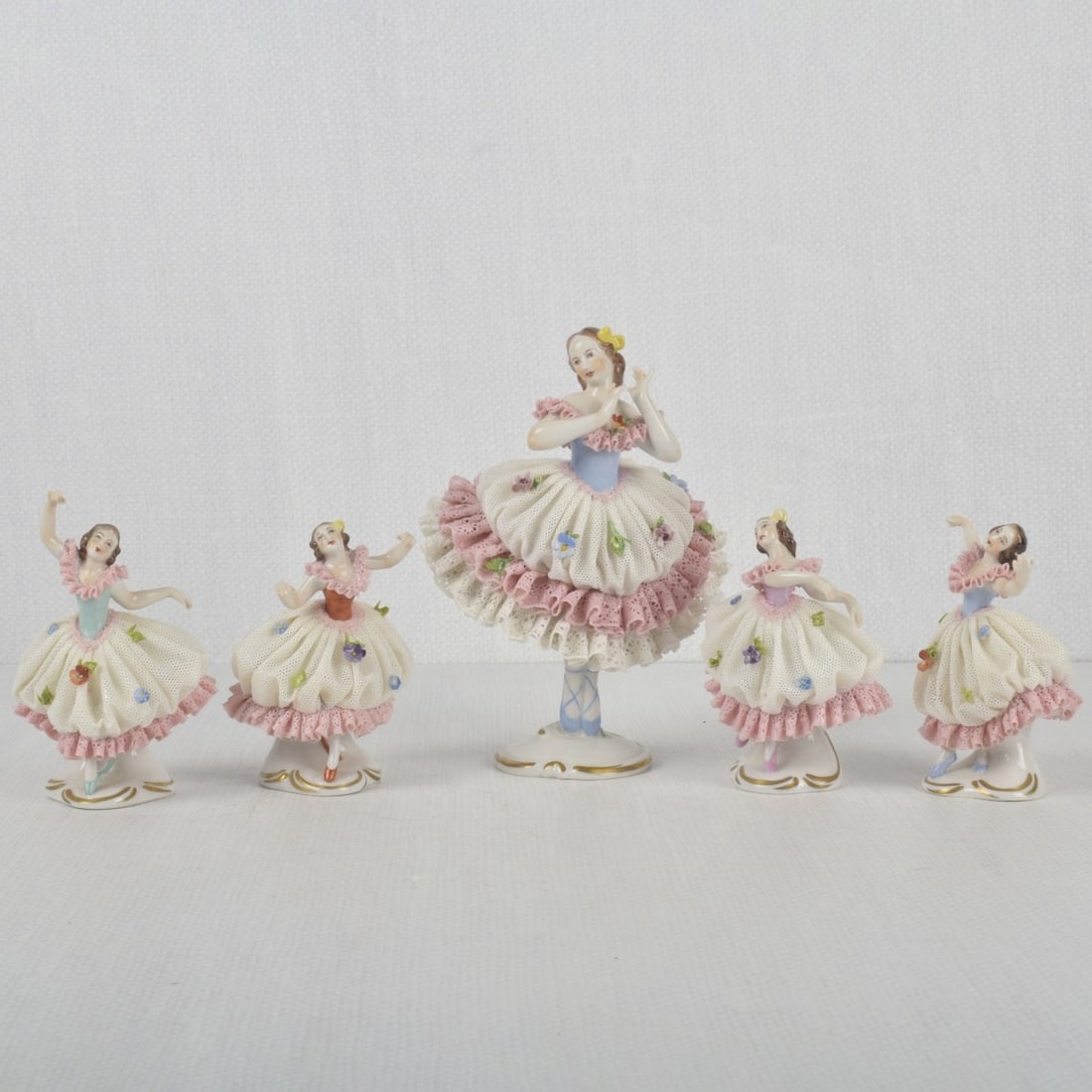 German Rudolstadt Volkstedt Figures: Five (5) German Rudolstadt Volkstedt Lace Porcelain Ballerina Figures. Properly marked to the undersides. Tallest measures: 6" high, 4-1/2" wide, 3-1/4" deep. Kodner Galleries offers phone and