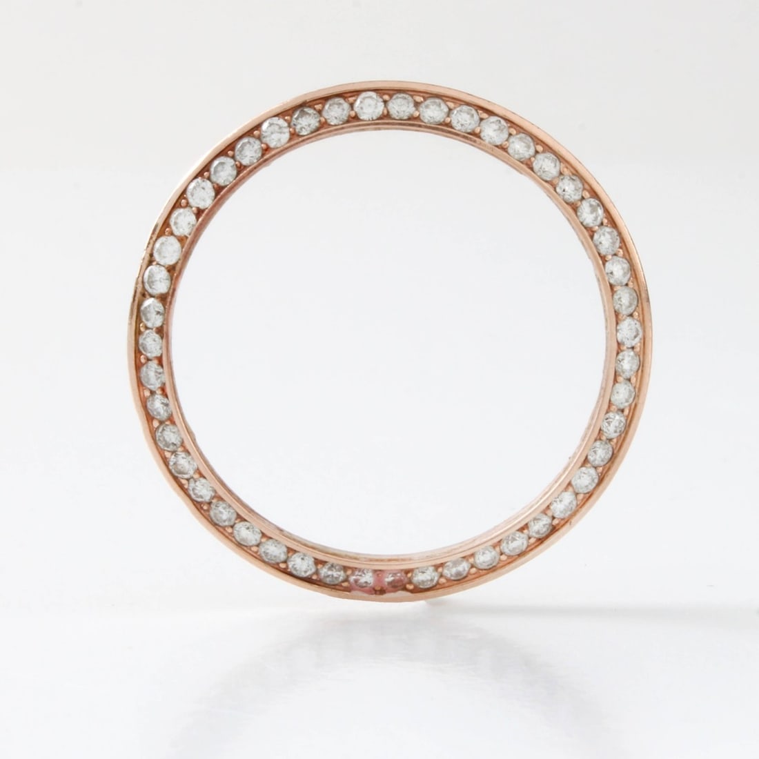 Diamond and 10K Watch Bezel: Vintage 10 Karat Rose Gold Watch Bezel Set with Small Round Cut Diamonds. Measures (outside diam.) 30.5mm, (inside diam.) 27.5mm. Approx. weight: 3.12 grams. Kodner Galleries offers phone and