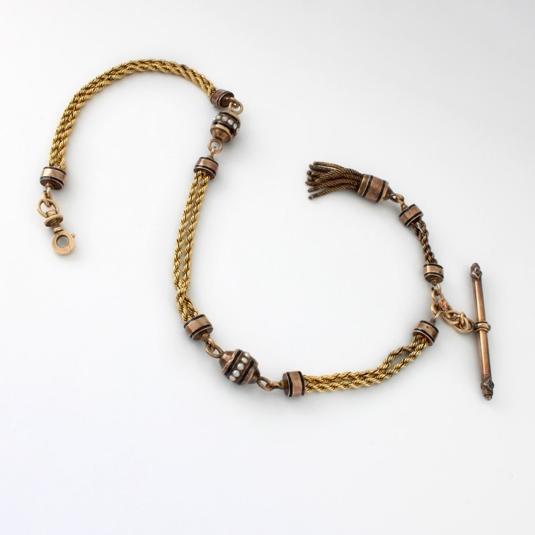 Antique 12K&18K Pocket Watch Chain: Antique 12 Karat and 18 Karat (tested) Yellow Gold Pocket Watch Chain with Seed Pearl Accents. Measures 12-7/8" L. Approx. weight: 23.60 grams. Kodner Galleries offers phone and absentee bidding at a