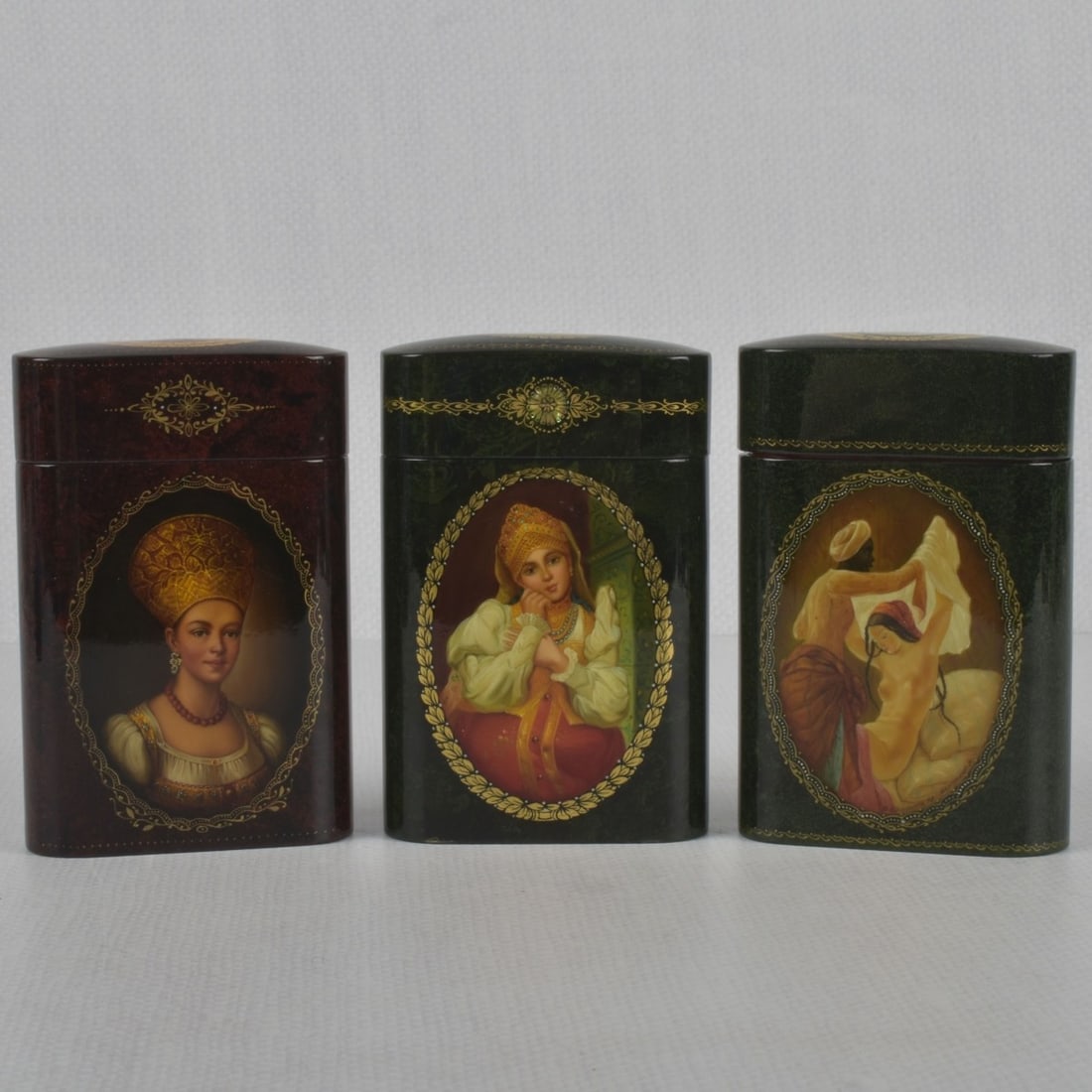 Russian Lacquer Papier Mache: Collection of Three (3) Russian Lacquer Papier Mache Cigarette Cases. Measures: 4-1/2" high, 2-7/8" wide, 1-1/16" deep. Kodner Galleries offers phone and absentee bidding at a low, flat 21% buyer?s