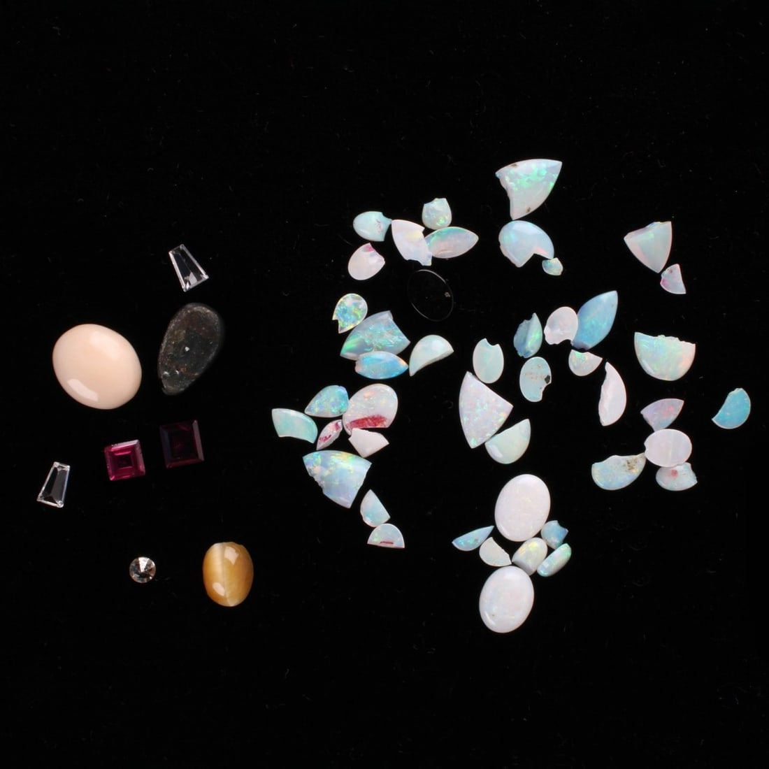 Loose Gemstones: Collection of Loose Gemstones. To include opals, two small tapered baguette cut diamonds, two baguette cut garnets, a tiger eye and an angel skin coral. Kodner Galleries offers phone and absentee