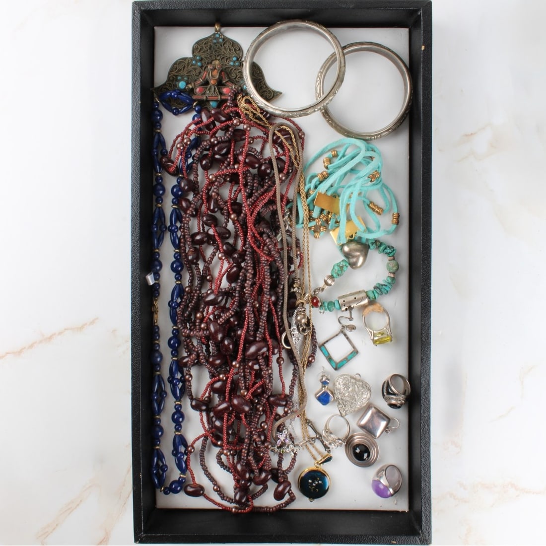 Lot of Costume Jewelry: Lot of Costume Jewelry. Including necklaces, rings, pendants, earrings, bangle bracelets. Kodner Galleries offers phone and absentee bidding at a low, flat 21% buyer?s premium without surcharge or