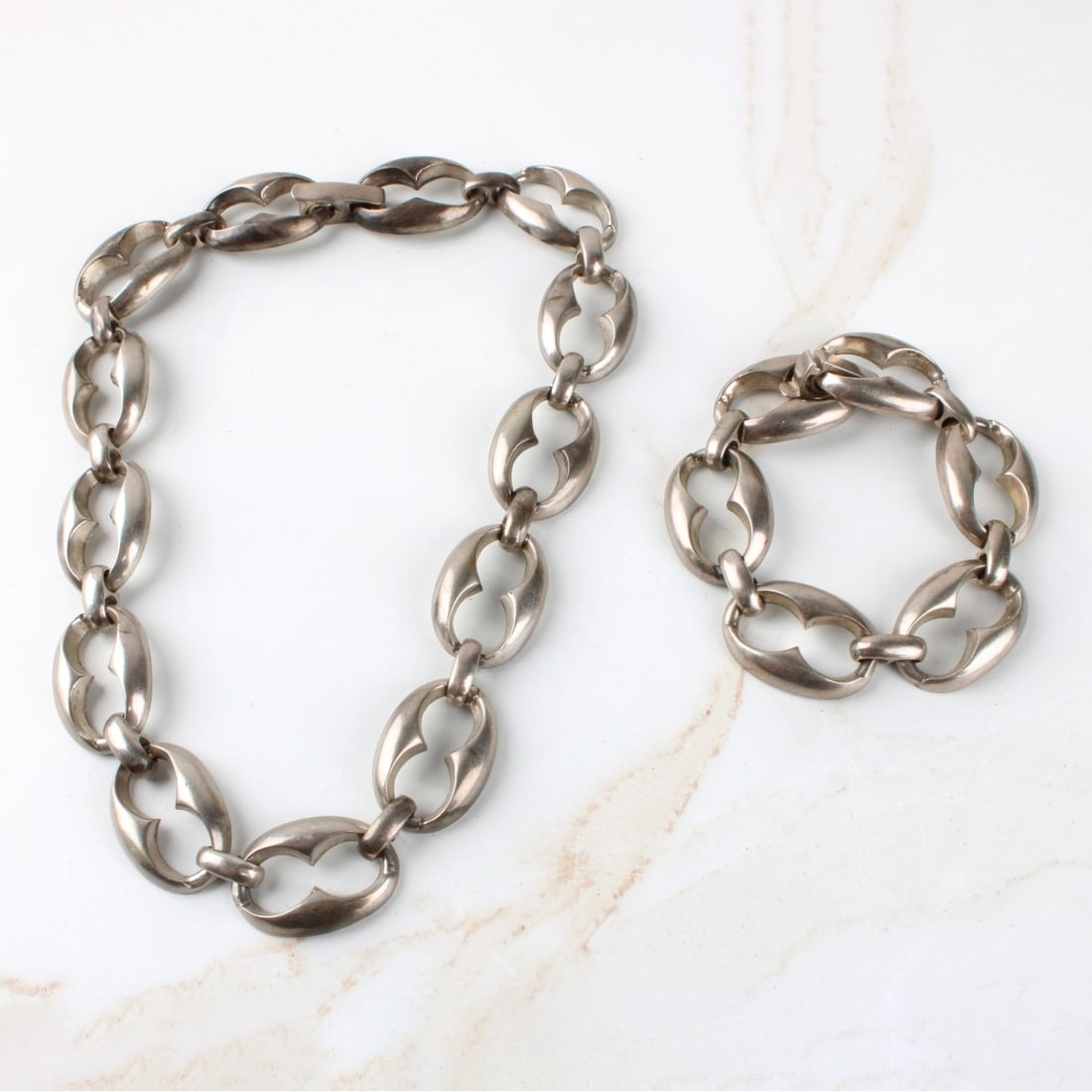 Sterling Silver Necklace and Bracelet: Vintage Chunky Sterling Silver Oval Shape Chain Necklace and Bracelet. Necklace measures: 16" long, bracelet measures: 7-1/8" long. Total weight: 153.00 grams. Kodner Galleries offers phone and