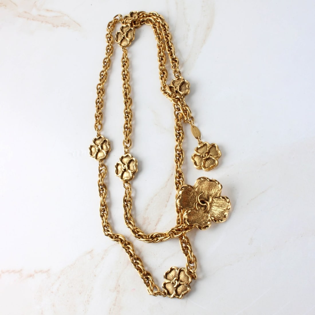 Vintage Chanel Clover Gold Toned Belt: Vintage Chanel Clover Gold Toned Belt. Measures: 37" long. Kodner Galleries offers phone and absentee bidding at a low, flat 21% buyer?s premium without surcharge or hidden fees. For information,