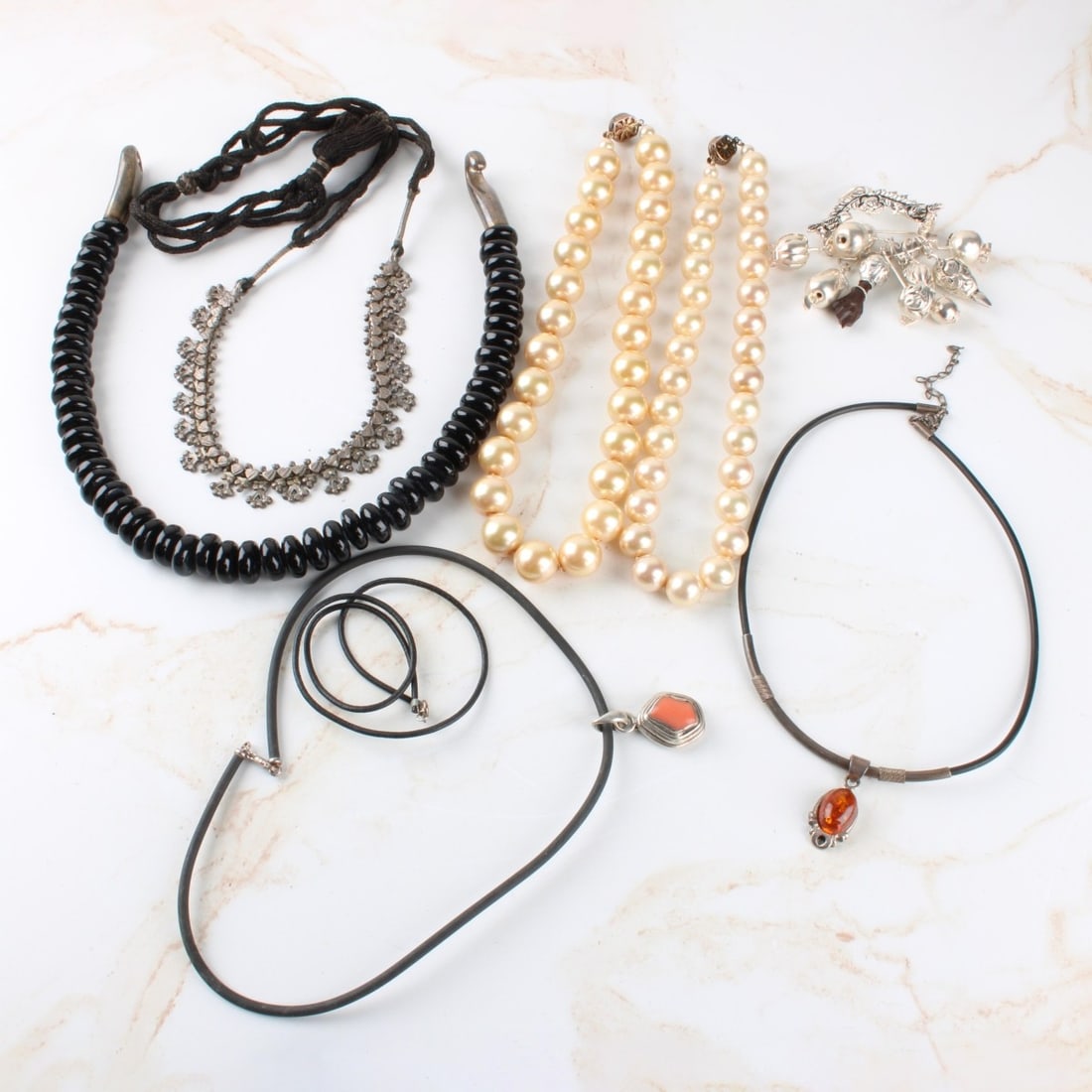 Lot of Sterling Silver Jewelry: Lot of Seven (7) Pieces Sterling Silver Jewelry. Consisting of one (1) brooch, weights: 32.80 grams, two (2) simulated pearl single strand necklaces with sterling 925 clasps: measures: 16" long, one