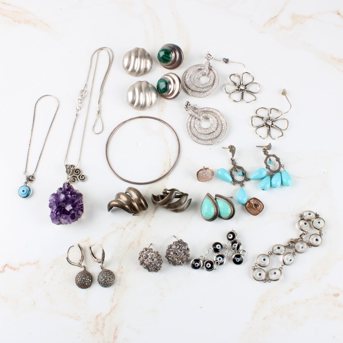 Lot of Sterling Silver Jewelry: Lot of Sterling Silver Jewelry, Earrings, bracelets, bracelets some with marcasite, stones, gem stones. Total gross weight: 162.20 grams. Kodner Galleries offers phone and absentee bidding at a low,