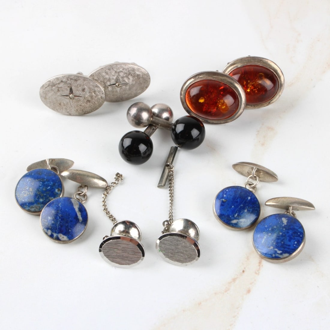 Sterling Silver Tray Lot of Men's Accessories: Sterling Silver Tray Lot of Men's Dress Accessories. Consisting of five (5) pair of cufflinks some with hard stones, two (2) tie clips (one missing rod). Total approximate weight: 58.90 grams. Kodner