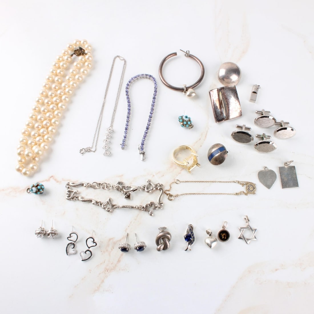 Lot of Sterling Silver Jewelry: Lot of Sterling Silver. Including cufflinks, necklaces, pendants,earrings. Total approximate gross weight: 185.01 grams. Kodner Galleries offers phone and absentee bidding at a low, flat 21% buyer?s
