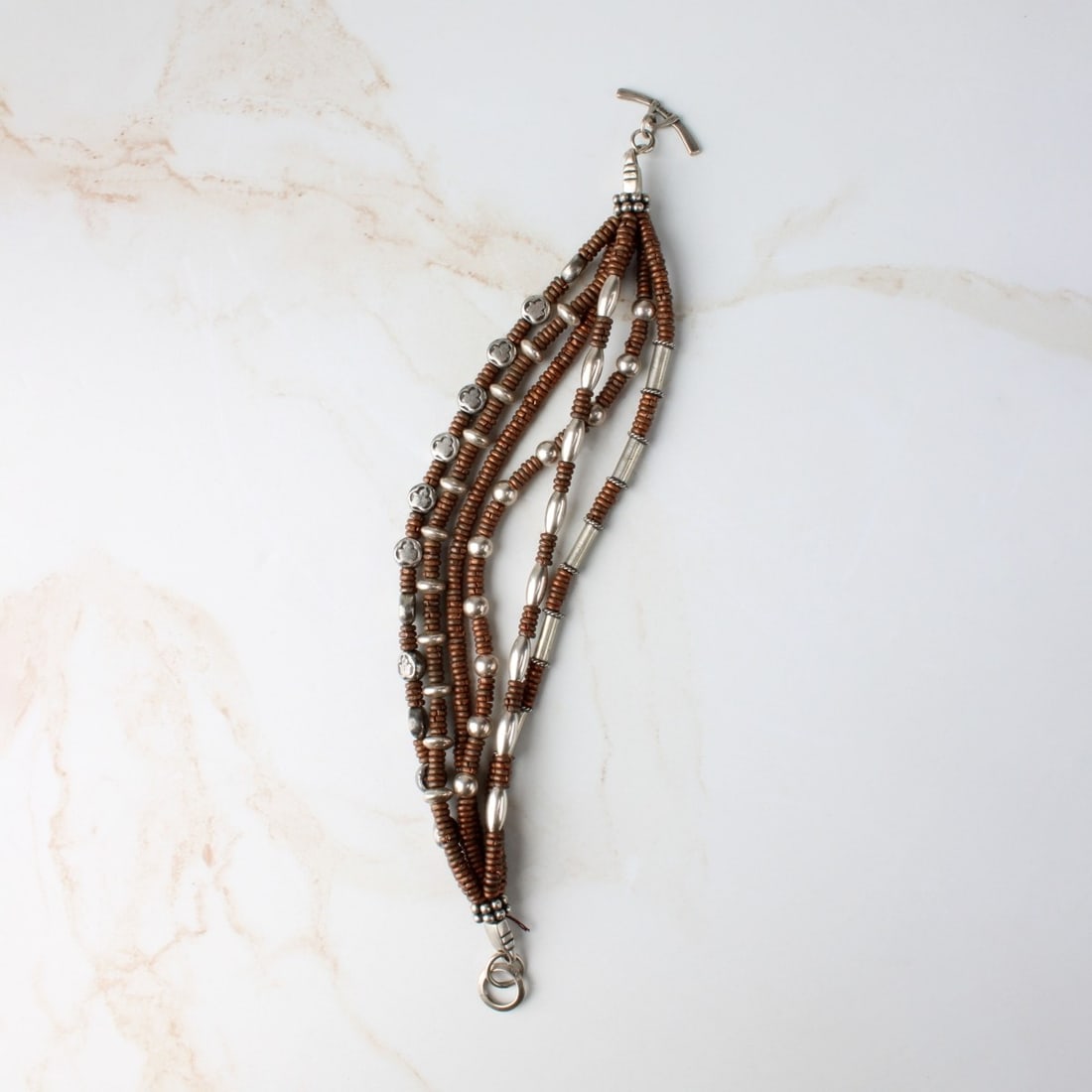 Sterling Silver and Copper Bracelet: Vintage Sterling Silver and Copper Bracelet. Stamped 925 to clasp. Measures 8-1/2" L. Approx. weight: 75.94 grams. Kodner Galleries offers phone and absentee bidding at a low, flat 21% buyer?s