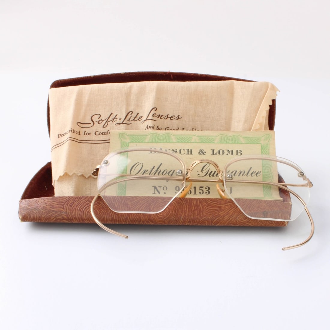 Bausch & Lomb 12K GF Glasses: Vintage Circa 1942 Bausch & Lomb 12 Karat Gold Filled Rimless Glasses. Signed, stamped 12K GF. With case and original "Orthogon Guarantee" dated 1942. Kodner Galleries offers phone and absentee