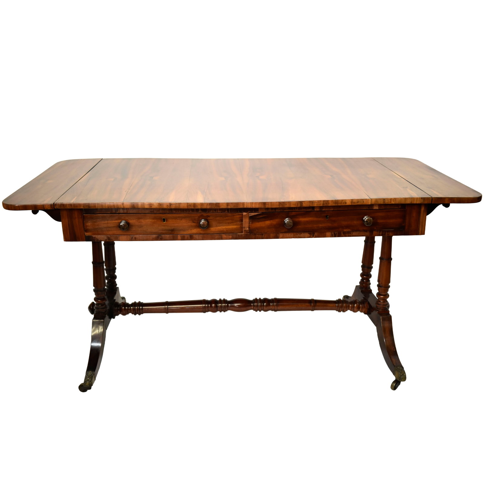 English Regency Desk: English Regency Mahogany and Rosewood Desk. Early 19th Century. Rectangular top with drop down leaves over two drawers over supports, two pulls with false drawers to one side with two turned posts wit