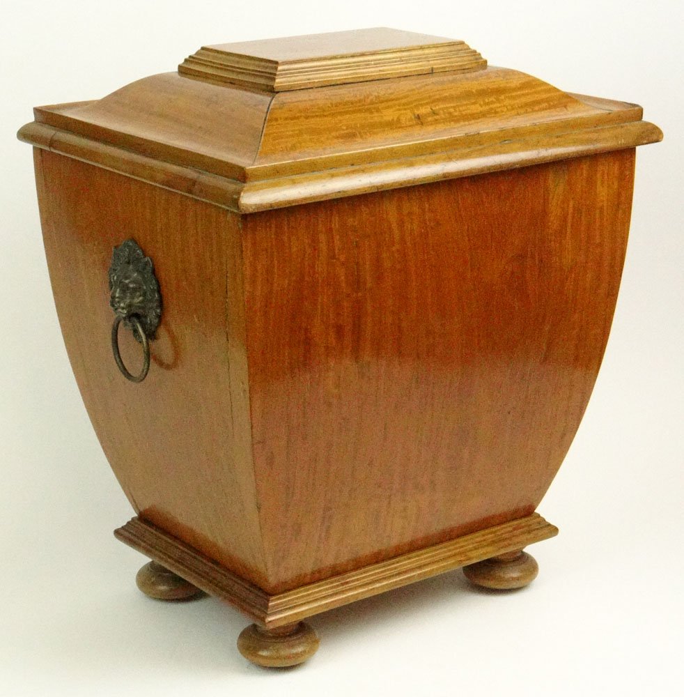 19th Century Continental Satinwood Cellarette of: 19th Century Continental Satinwood Cellarette of Sarcophagus Form with Bun Feet and Lion Mask Handles. Unsigned. A Bubble to Back or else Good to Very Good Condition. Measures 19 Inches Tall and 16-1/