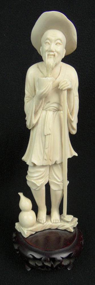 Carved Chinese Ivory Figure of a Man Holding a Cup: Carved Chinese Ivory Figure of a Man Holding a Cup Mounted on a Wood Base. Unsigned. Very Good Condition. Measures 8-1/4 Inches Tall by 3 Inches Long and 1-1/2 inches Wide. Base Measures 1-1/2 Inches 