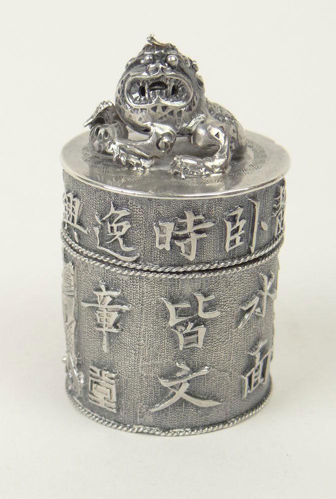 19/20th Century Chinese Export Silver Cylindrical Form: 19/20th Century Chinese Export Silver Cylindrical Form Box and Seal. The Lid Adorned with a Foo-Dog. The Sides Profusely Decorated with Repousse Diorama and Chinese Characters. The Underside with Chin