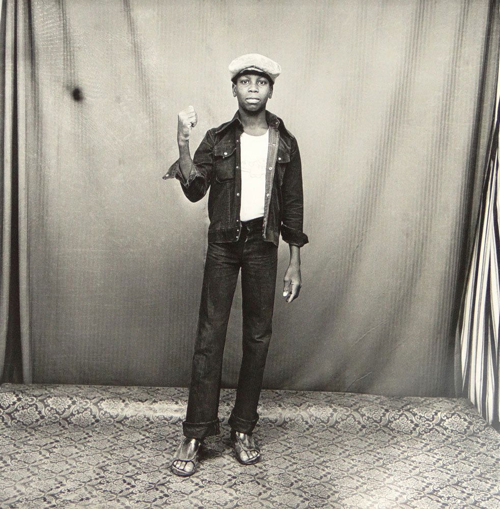 Malick Sidibé, Malian (Born 1936) Circa 2007 Silver: Malick Sidibé, Malian (Born 1936) Circa 2007 Silver Gelatin Print "Je suis un blouzou noir-1976". Signed and Dated Lower Right. Small Tear Upper Right Edge of Paper Otherwise Good Condition. Image Me