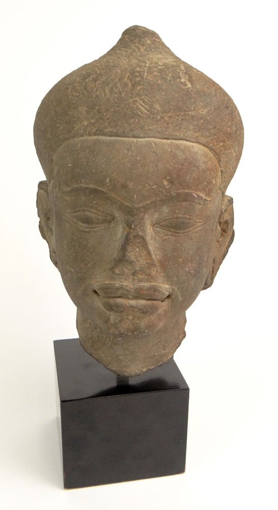 Probably 12/13th Century Cambodian Khmer Baphvon style: Probably 12/13th Century Cambodian Khmer Baphvon style Carved Red Sandstone Buddha Head Attached to Wood Base. Unsigned. Losses Consistent with Age, Good Condition. Measures 12-1/2 Inches Tall and 7 I