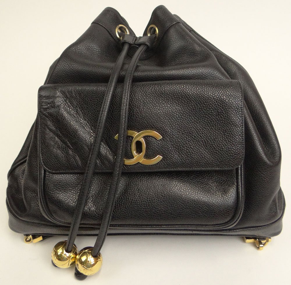 Black Leather Chanel Backpack with Chanel Logo. Signed: Black Leather Chanel Backpack with Chanel Logo. Signed Chanel, Paris. Good Used Condition or Better. Measures 10 Inches by 12 Inches Not Counting Straps. Shipping $36.00
