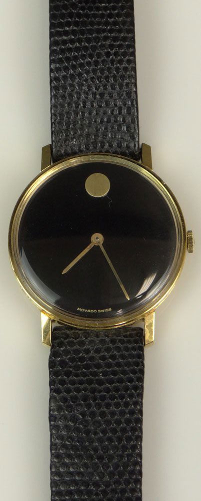Man's Vintage Swiss Made Movado Museum Manual Movement: Man's Vintage Swiss Made Movado Museum Manual Movement Watch with Leather Strap. Signed. Minor Surface Wear Otherwise Good Running Condition with Box. Case Measures 1-1/8 Inches Diameter. Strap Measur