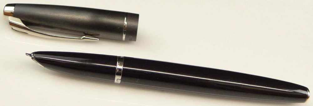 French Parker Pen with Black Body and Charcoal Gray: French Parker Pen with Black Body and Charcoal Gray Cap. Sgned Parker and France L. Rubbing, Scratching or else Good Condition. No Box, No Paperwork. Measures 5 Inches Long without Cap and 5-5/8 Inche