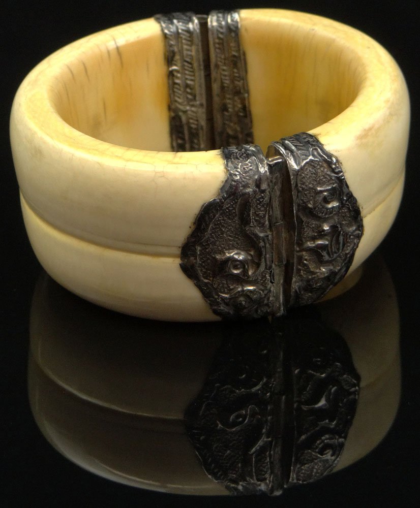 Mid 20th Century Cross Hatched Ivory Bracelet with: Mid 20th Century Cross Hatched Ivory Bracelet with Silvertone Metal Mounts and Hinge. Unsigned. Interior Ivory Sections Showing Fissures not coming through the surface. Good to Very Good Condition. In