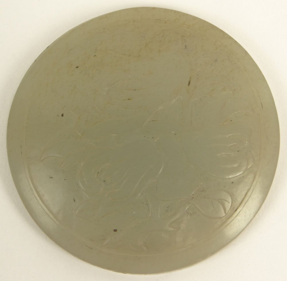 Carved Chinese pale celadon almost white jade: Carved Chinese pale celadon almost white jade medallion. The Front carved with a motif of Buddha Hand Citron Flowers. The back is concave. We believe this was set into a scepter at one time. Unsigned.